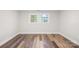 Light-filled bedroom featuring wood-look floors, two windows with views, and neutral paint at 716 W Graham St, Shelby, NC 28150