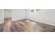 Bright bedroom featuring wood-look flooring, natural light, and fresh neutral paint at 716 W Graham St, Shelby, NC 28150