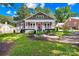 Charming home featuring red shutters, a cozy front porch, and lovely landscaping at 716 W Graham St, Shelby, NC 28150