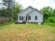 View of the back of the home featuring a cozy patio area with a large, grassy lawn at 720 4Th St, Stanley, NC 28164