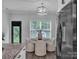 Dining area featuring round table, four chairs, light fixture, and stainless steel fridge at 720 4Th St, Stanley, NC 28164
