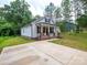 Charming home featuring a brick-lined front porch and long driveway at 720 4Th St, Stanley, NC 28164