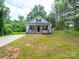Charming home featuring a brick-lined front porch and beautifully maintained landscaping at 720 4Th St, Stanley, NC 28164