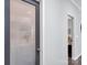 Hallway view of laundry room with decorative glass door and doorway to bedroom at 720 4Th St, Stanley, NC 28164