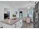 View of kitchen island with granite countertop and view to dining area and living room at 720 4Th St, Stanley, NC 28164