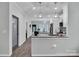 Bright kitchen featuring white cabinets, granite counters, stainless steel appliances, and open layout to dining area at 720 4Th St, Stanley, NC 28164