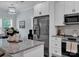 Bright kitchen with white cabinets, granite countertops, and stainless steel appliances open to dining area at 720 4Th St, Stanley, NC 28164