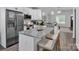 Bright kitchen features stainless steel appliances, granite countertops, and an island with seating at 720 4Th St, Stanley, NC 28164