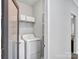 The laundry room is equipped with a washer, dryer, shelving, and plenty of natural light at 720 4Th St, Stanley, NC 28164