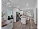 Open floor plan showcasing the kitchen, dining area, and living room with modern finishes and ample natural light at 720 4Th St, Stanley, NC 28164