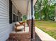 Inviting covered front porch features brick columns and comfortable seating at 720 4Th St, Stanley, NC 28164