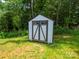 View of a backyard shed with a gray and white exterior finish, and an A-frame style door at 720 4Th St, Stanley, NC 28164