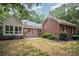 Exterior backyard view featuring a pergola, deck, and lush landscaping, connecting indoor and outdoor living spaces at 7408 Mockingbird Ln, Waxhaw, NC 28173
