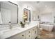 Modern bathroom features dual sinks, marble countertops, a soaking tub, and a separate shower at 7408 Mockingbird Ln, Waxhaw, NC 28173