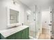 Charming bathroom featuring a glass shower and a vanity with a marble countertop at 7408 Mockingbird Ln, Waxhaw, NC 28173