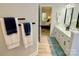 Bright bathroom with double vanity, wood floors and a view into the main bedroom at 7408 Mockingbird Ln, Waxhaw, NC 28173