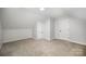 Bright bedroom featuring neutral carpet, white walls, with two doors providing access to other areas of the home at 7408 Mockingbird Ln, Waxhaw, NC 28173