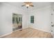 Bright bedroom with a ceiling fan and natural light from the window and attached sunroom at 7408 Mockingbird Ln, Waxhaw, NC 28173