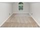 Neutral bonus room with carpeted floors and a small arched window, offering ample space at 7408 Mockingbird Ln, Waxhaw, NC 28173