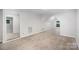 Large, carpeted bonus room with a vaulted ceiling and a small arched window at 7408 Mockingbird Ln, Waxhaw, NC 28173