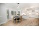 Bright dining area featuring modern lighting and access to the kitchen and outdoor views at 7408 Mockingbird Ln, Waxhaw, NC 28173