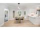 Bright dining area featuring modern lighting and access to the kitchen and outdoor views at 7408 Mockingbird Ln, Waxhaw, NC 28173