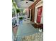 Inviting covered front porch featuring rocking chairs, ferns, flower pots and brick accents at 7408 Mockingbird Ln, Waxhaw, NC 28173