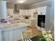 Well-lit kitchen showcases white cabinets, quartz countertops, and stainless steel appliances at 7408 Mockingbird Ln, Waxhaw, NC 28173