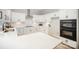 Modern kitchen with white cabinets, quartz countertops, and stainless steel appliances, perfect for culinary enthusiasts at 7408 Mockingbird Ln, Waxhaw, NC 28173