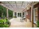 Inviting outdoor patio with a wooden pergola, brick siding, and comfortable seating perfect for relaxation at 7408 Mockingbird Ln, Waxhaw, NC 28173