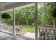 Covered front porch offering a serene view of the lush backyard, creating a relaxing outdoor space at 7408 Mockingbird Ln, Waxhaw, NC 28173