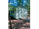 Charming backyard shed with unique double doors and a small window, providing ample storage space at 7408 Mockingbird Ln, Waxhaw, NC 28173
