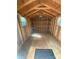 Inside of storage shed shows ample storage, wooden construction and two windows for plenty of light at 7408 Mockingbird Ln, Waxhaw, NC 28173