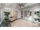 Spacious sunroom with a ceiling fan, large windows, and access to an outdoor patio at 7408 Mockingbird Ln, Waxhaw, NC 28173