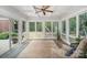 Bright sunroom with many windows offering wooded views, chair and rug at 7408 Mockingbird Ln, Waxhaw, NC 28173