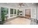 Inviting sunroom featuring large windows, a ceiling fan, and a patterned accent chair at 7408 Mockingbird Ln, Waxhaw, NC 28173
