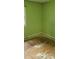 Bedroom view with green walls, showing damaged floors and electrical outlets at 7705 Stone Canyon Ln, Charlotte, NC 28227