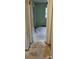 A view from one room to the next with door trim, damaged floor, and a window at 7705 Stone Canyon Ln, Charlotte, NC 28227