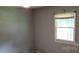 Bedroom with a window providing natural light and a neutral color scheme at 7705 Stone Canyon Ln, Charlotte, NC 28227