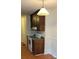 Kitchen area with a range, dark wooden cabinets, and a classic pendant light fixture at 7705 Stone Canyon Ln, Charlotte, NC 28227