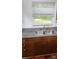 Close up of kitchen sink and cabinet, with window view and damage at 7705 Stone Canyon Ln, Charlotte, NC 28227