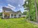 Spacious backyard with green grass, back patio and home exterior at 822 River Oaks Ln, Charlotte, NC 28226