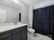 Bathroom with a white marble floor, black vanity and framed mirror at 822 River Oaks Ln, Charlotte, NC 28226