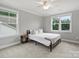 Bedroom with large windows, neutral walls, and a comfortable bed with a decorative throw at 822 River Oaks Ln, Charlotte, NC 28226