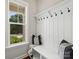 Charming entryway with a built-in bench, coat hooks, and a large window providing natural light at 822 River Oaks Ln, Charlotte, NC 28226