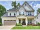 Beautiful two story home with a well manicured lawn, two-car garage, and inviting front porch at 822 River Oaks Ln, Charlotte, NC 28226