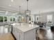 Open concept kitchen with a large island, stylish pendant lights, and seamless flow to the living area at 822 River Oaks Ln, Charlotte, NC 28226