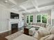 Spacious living room with coffered ceilings, fireplace, and large windows that offer wooded views at 822 River Oaks Ln, Charlotte, NC 28226