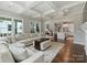 Open-concept living room showcases a large sectional sofa, coffered ceilings and kitchen access at 822 River Oaks Ln, Charlotte, NC 28226