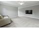 Spacious living room featuring plush sofa, neutral walls, and large TV for entertaining at 822 River Oaks Ln, Charlotte, NC 28226